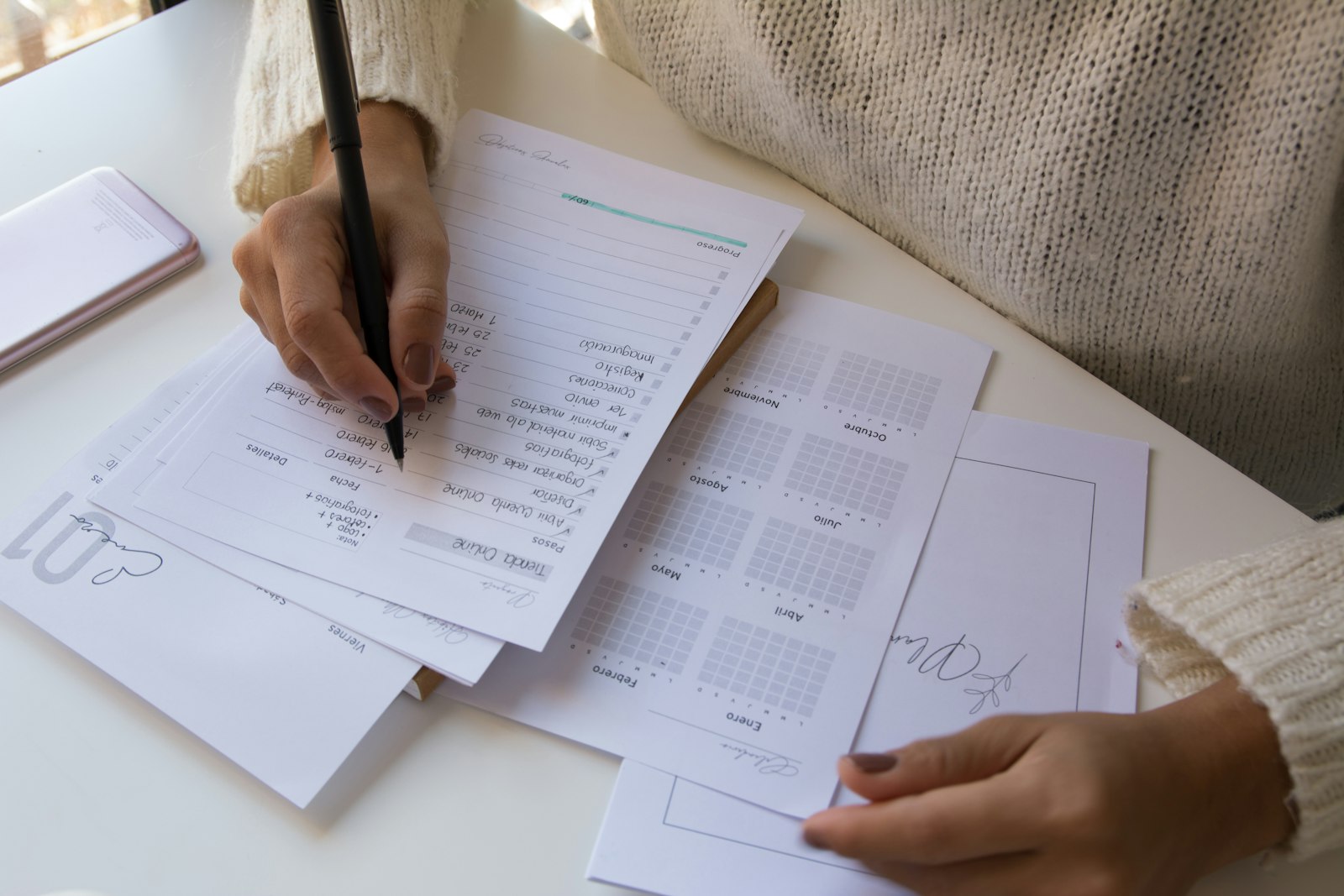 A person at a desk organising receipts and correspondence