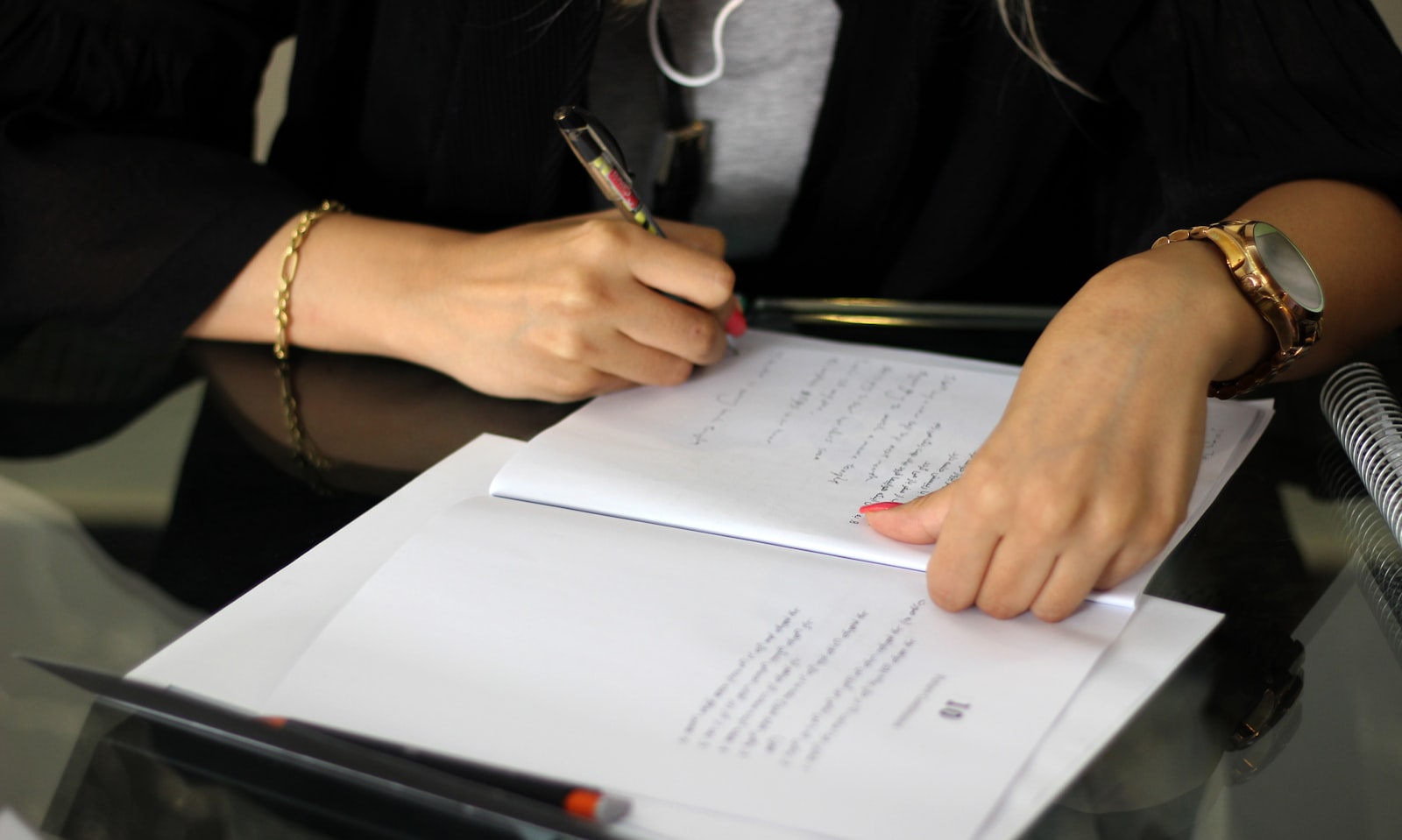 A person reviewing a printed contract with a pen