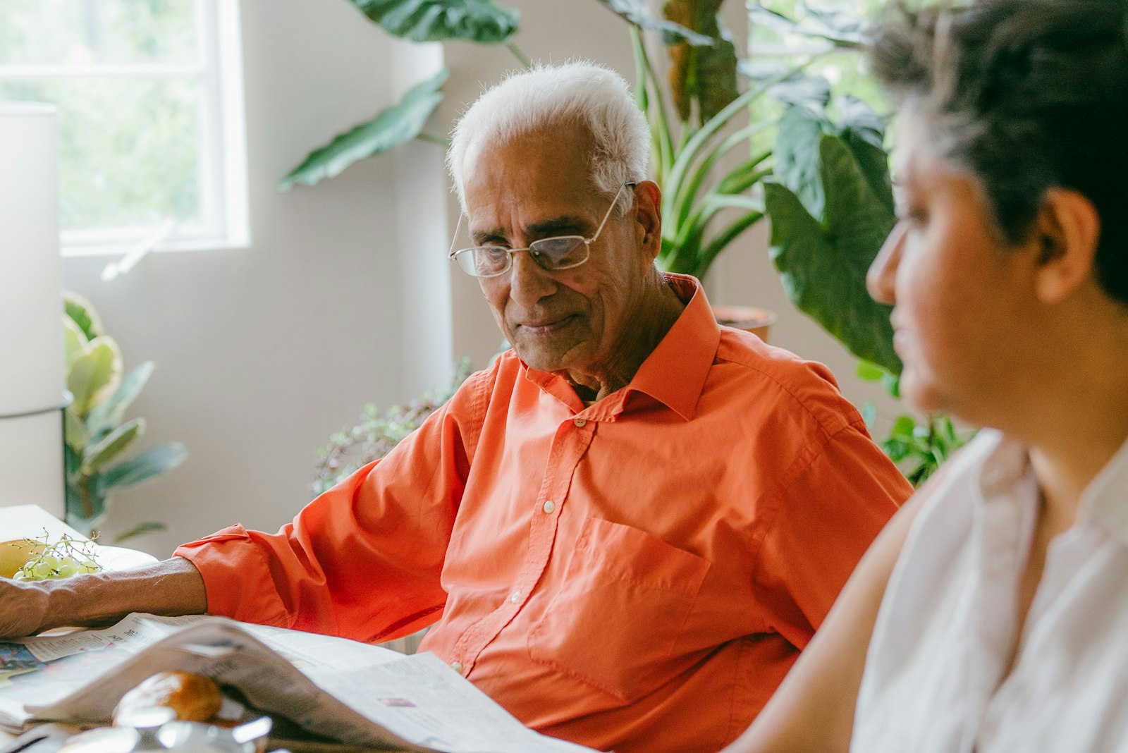 An older and younger person looking at documents together